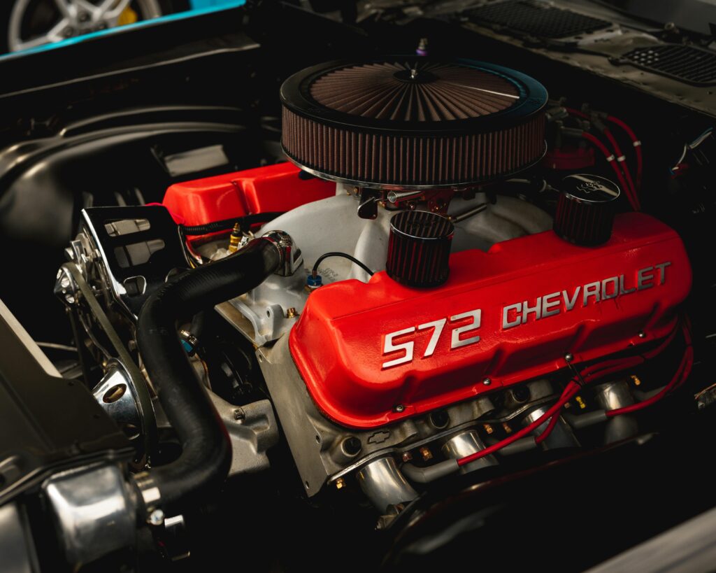 Detailed closeup of a Chevrolet 572 engine with vibrant red valve covers.